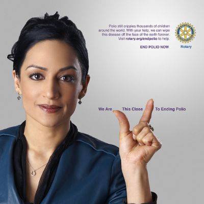 She is seen using her hand to show a size referring to hw close they are to ending polio.